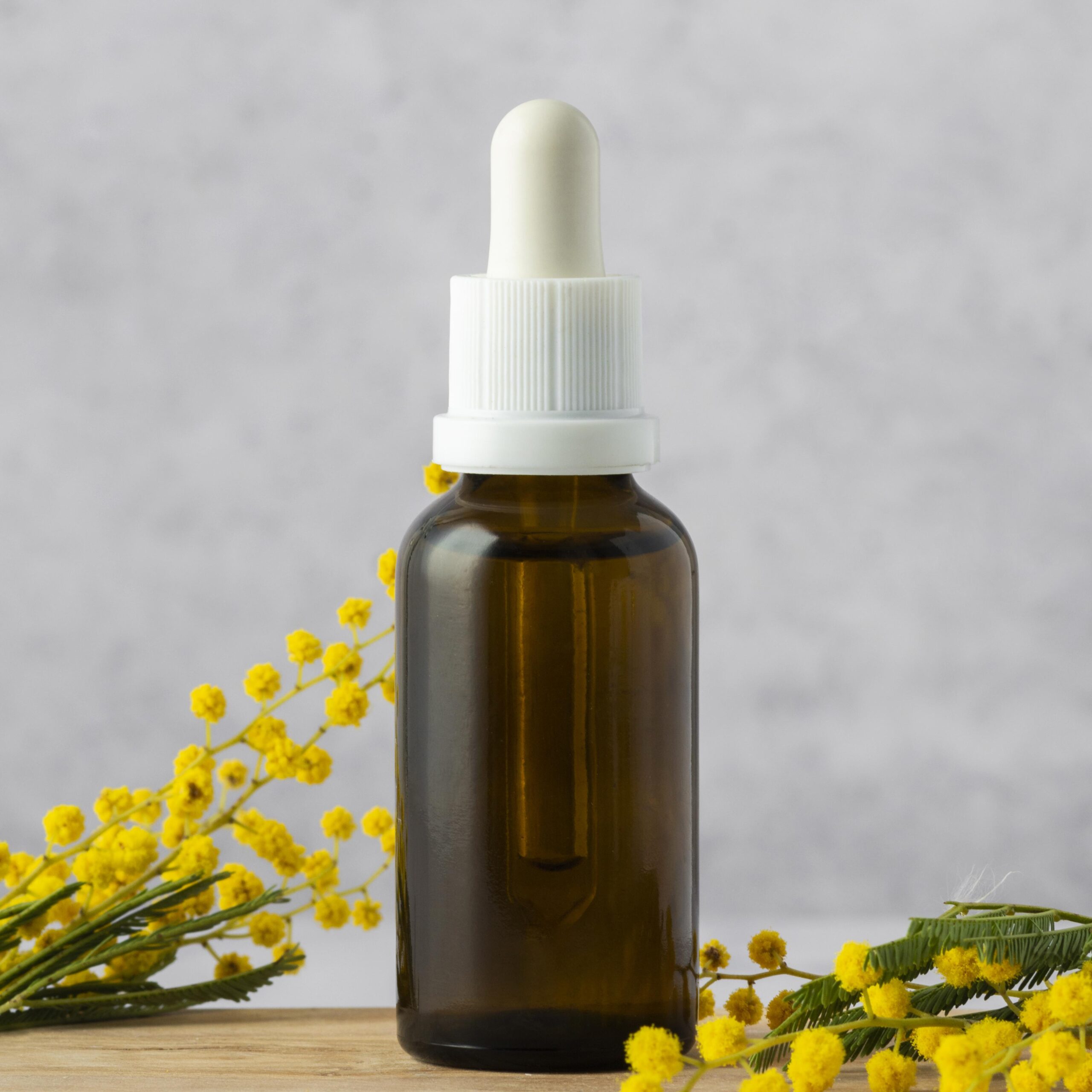 Flower essence bottle with yellow flowers.